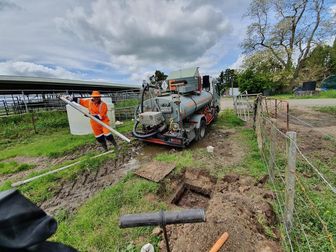 Specialist emptying septic tank with pipe