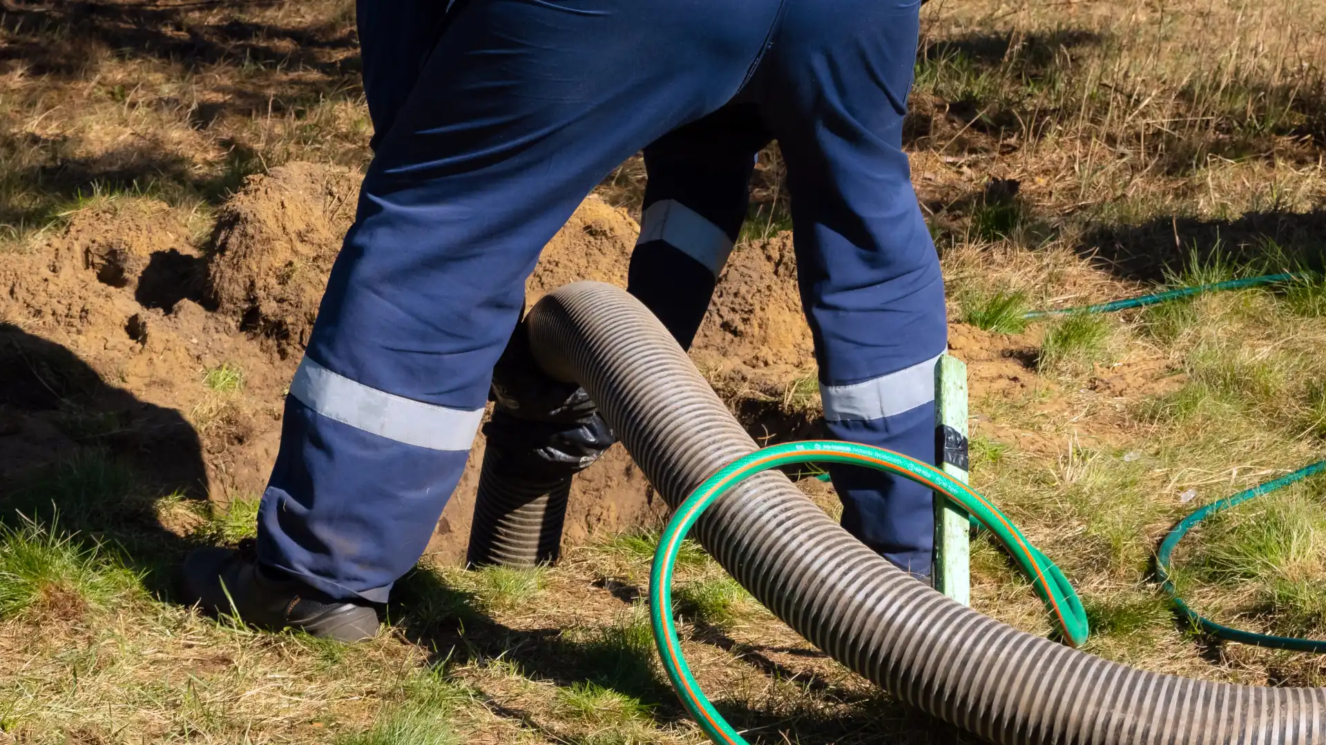 Replace or repair broken drain pipe - A man working on drain pipes outside
